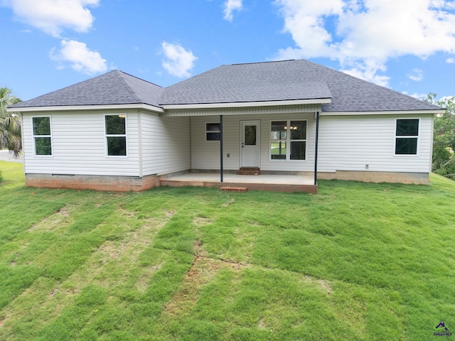 219 Christine Cir, Perry, GA 31069 - back of house with a patio area, a lawn, and roof with shingles