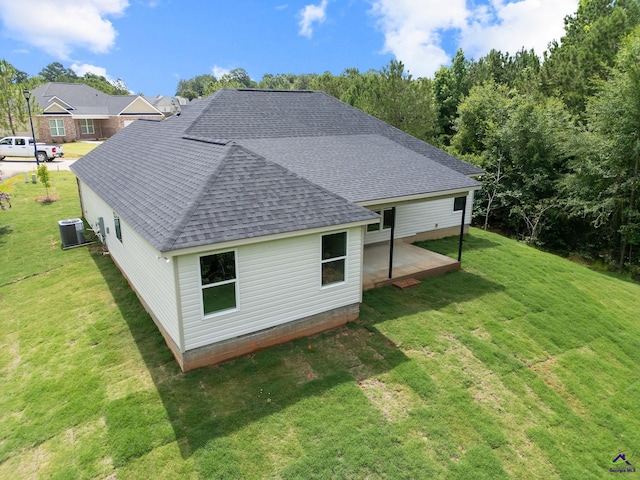 219 Christine Cir, Perry, GA 31069 - back of property with roof with shingles, a yard, and a patio area