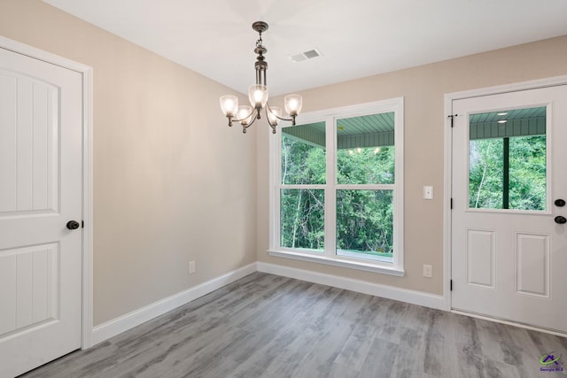219 Christine Cir, Perry, GA 31069 - unfurnished dining area with a chandelier and wood finished floors