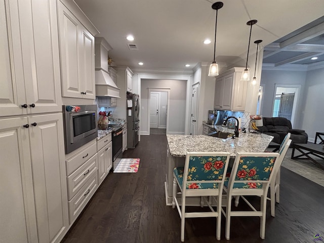 400 Rustic Live Oak Trl, Bonaire, GA 31005 - kitchen featuring appliances with stainless steel finishes, ornamental molding, a breakfast bar area, dark wood-style flooring, and a peninsula