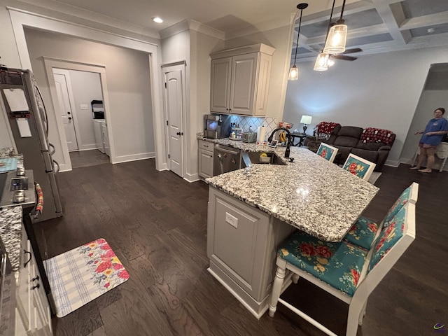 400 Rustic Live Oak Trl, Bonaire, GA 31005 - kitchen featuring ceiling fan, light stone counters, stainless steel appliances, a peninsula, and decorative backsplash