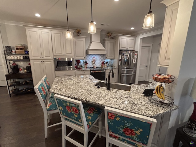 400 Rustic Live Oak Trl, Bonaire, GA 31005 - kitchen with stainless steel appliances, custom exhaust hood, white cabinetry, dark wood finished floors, and light stone counters