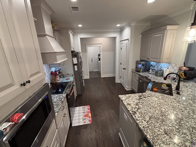 400 Rustic Live Oak Trl, Bonaire, GA 31005 - kitchen featuring stainless steel appliances, light stone counters, tasteful backsplash, crown molding, and dark wood-type flooring