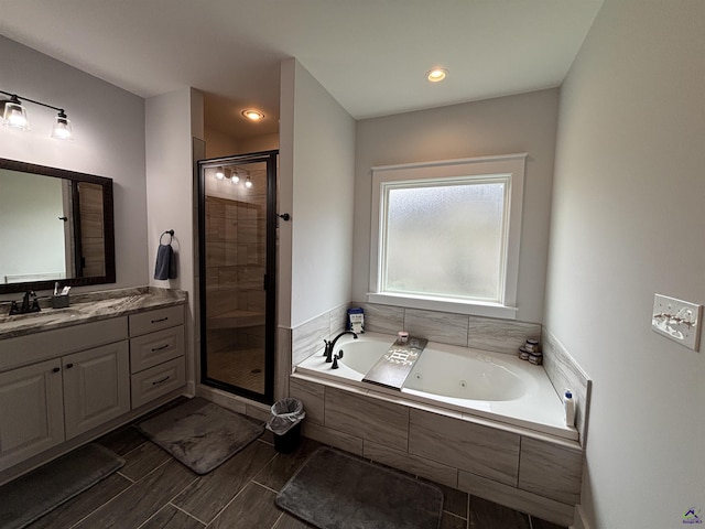 400 Rustic Live Oak Trl, Bonaire, GA 31005 - bathroom with a tub with jets, a stall shower, vanity, and recessed lighting