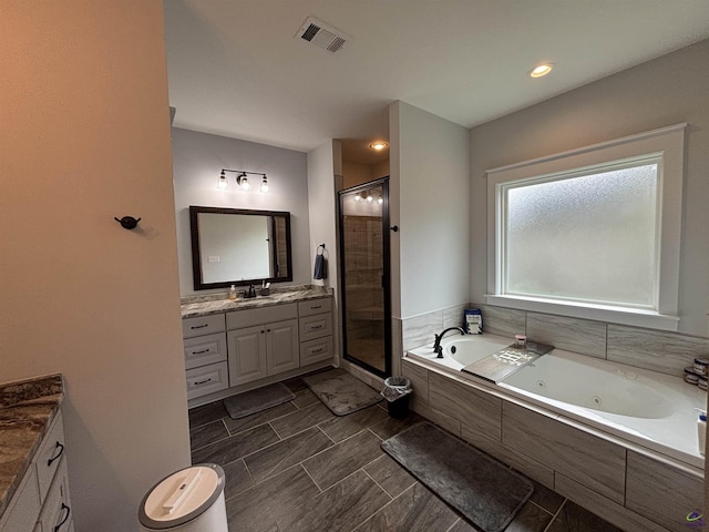 400 Rustic Live Oak Trl, Bonaire, GA 31005 - bathroom featuring vanity, a stall shower, and a jetted tub