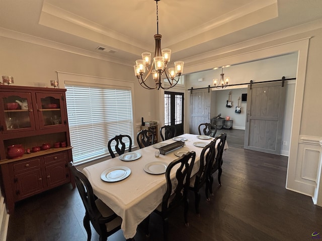 400 Rustic Live Oak Trl, Bonaire, GA 31005 - dining space featuring a barn door, a raised ceiling, a chandelier, dark wood-style floors, and ornamental molding