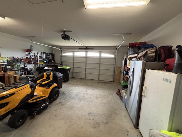 400 Rustic Live Oak Trl, Bonaire, GA 31005 - garage featuring a garage door opener and freestanding refrigerator