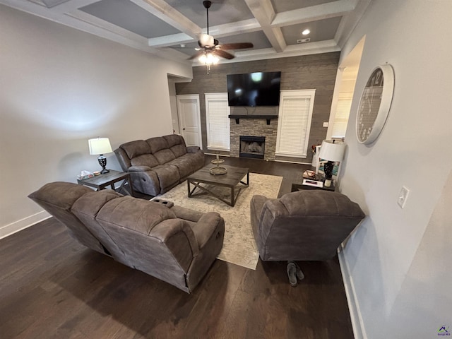 400 Rustic Live Oak Trl, Bonaire, GA 31005 - living room featuring coffered ceiling, beamed ceiling, ceiling fan, a stone fireplace, and dark wood-style floors