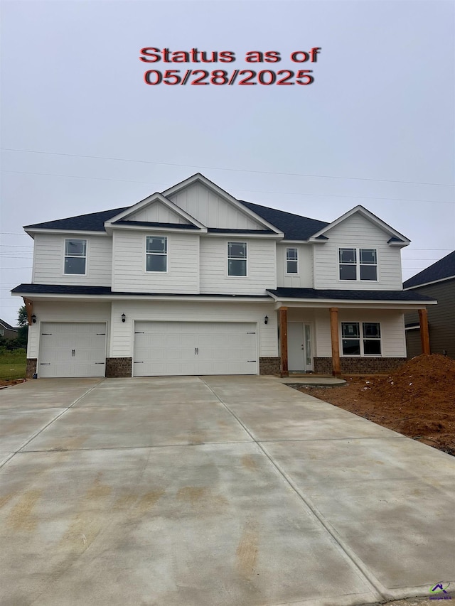 210 Ashley Nicole Ave, Bonaire, GA 31005 - view of front facade featuring a garage, driveway, board and batten siding, and brick siding