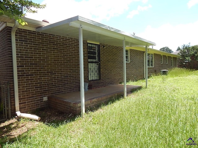 3498 Sandy Cir, Macon, GA 31216 - view of home's exterior with brick siding and a lawn