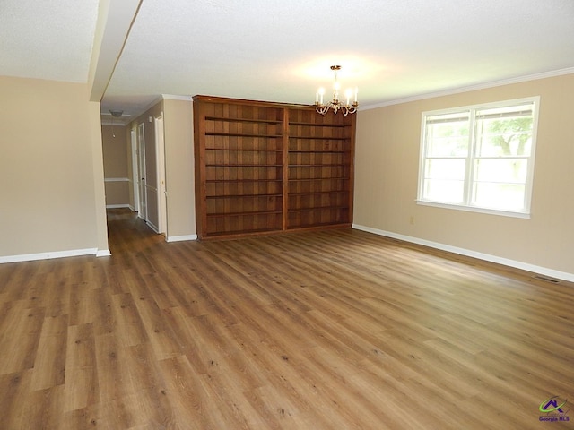 3498 Sandy Cir, Macon, GA 31216 - unfurnished room featuring ornamental molding, a chandelier, and light wood finished floors