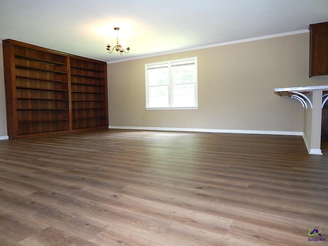 3498 Sandy Cir, Macon, GA 31216 - unfurnished living room with a chandelier, crown molding, and wood finished floors