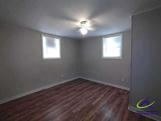 107 Roberts St, Warner Robins, GA 31093 - empty room with plenty of natural light, dark wood-style flooring, and a ceiling fan