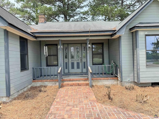 7285 Nowell Rd S, Macon, GA 31216 - entrance to property with covered porch, a chimney, and roof with shingles
