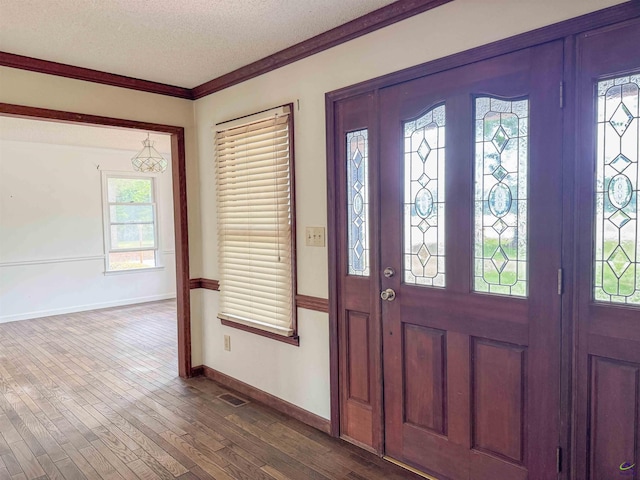 7285 Nowell Rd S, Macon, GA 31216 - entryway featuring a textured ceiling, dark wood-style flooring, and crown molding