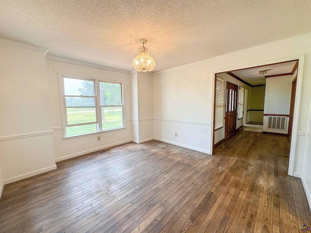 7285 Nowell Rd S, Macon, GA 31216 - empty room featuring dark wood-type flooring, ornamental molding, a textured ceiling, and a chandelier