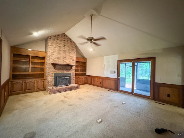 7285 Nowell Rd S, Macon, GA 31216 - unfurnished living room featuring built in shelves, a wainscoted wall, vaulted ceiling, ceiling fan, and carpet flooring