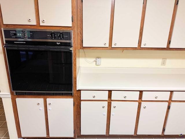 7285 Nowell Rd S, Macon, GA 31216 - kitchen with oven, white cabinetry, and light countertops