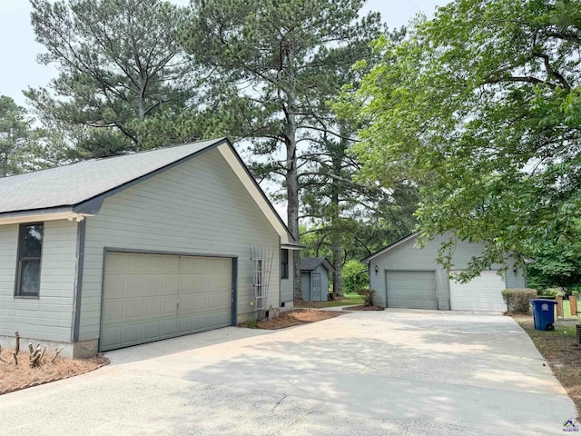 7285 Nowell Rd S, Macon, GA 31216 - view of side of property with a detached garage and an outbuilding
