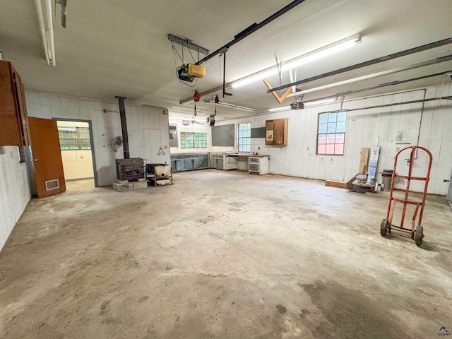 7285 Nowell Rd S, Macon, GA 31216 - garage with a wood stove and a garage door opener