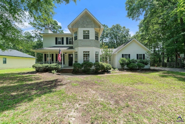 109 S Hiley Ct, Bonaire, GA 31005 - victorian home featuring covered porch, a front yard, and a chimney