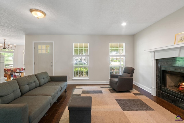109 S Hiley Ct, Bonaire, GA 31005 - living area featuring wood finished floors, a textured ceiling, a premium fireplace, a chandelier, and recessed lighting