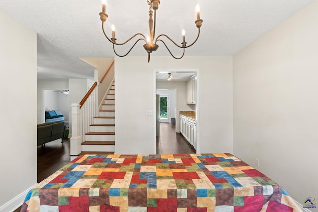 109 S Hiley Ct, Bonaire, GA 31005 - dining space with a chandelier, dark wood-style flooring, stairs, and a textured ceiling