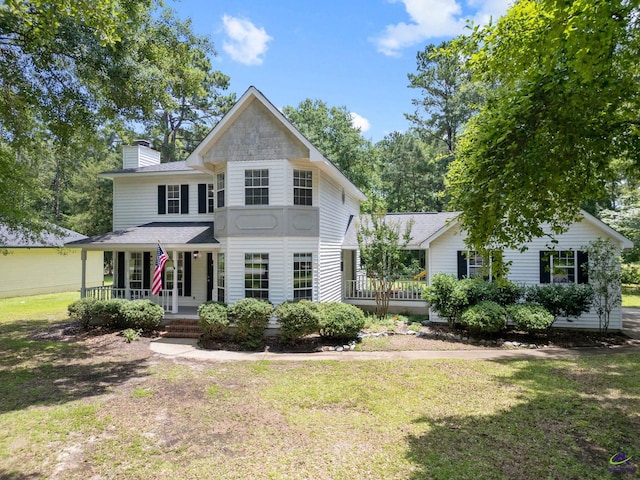 109 S Hiley Ct, Bonaire, GA 31005 - view of front of property featuring covered porch, a chimney, a front lawn, and roof with shingles