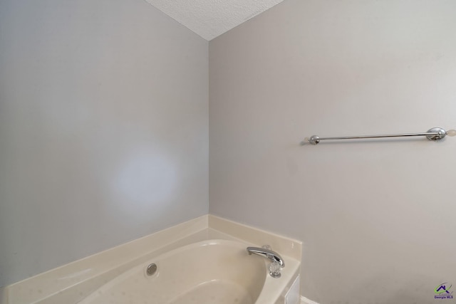 109 S Hiley Ct, Bonaire, GA 31005 - bathroom with a textured ceiling and a garden tub