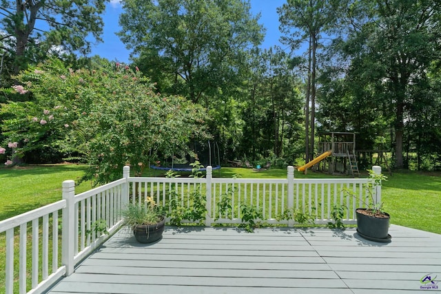 109 S Hiley Ct, Bonaire, GA 31005 - wooden terrace featuring a playground, a lawn, and a trampoline