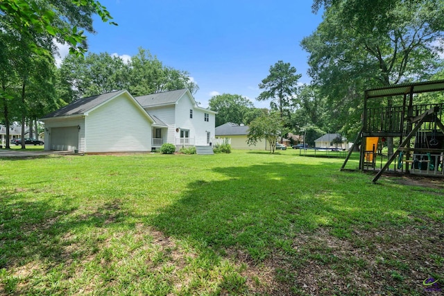 109 S Hiley Ct, Bonaire, GA 31005 - view of grassy yard featuring a trampoline, a playground, and an attached garage