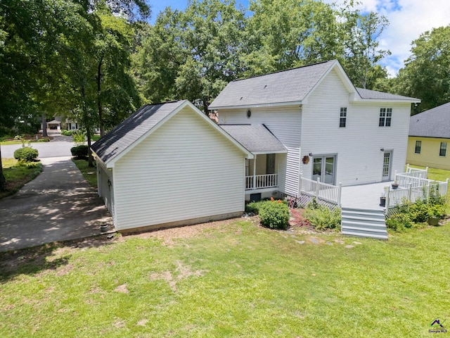 109 S Hiley Ct, Bonaire, GA 31005 - back of property featuring a lawn, roof with shingles, and a deck