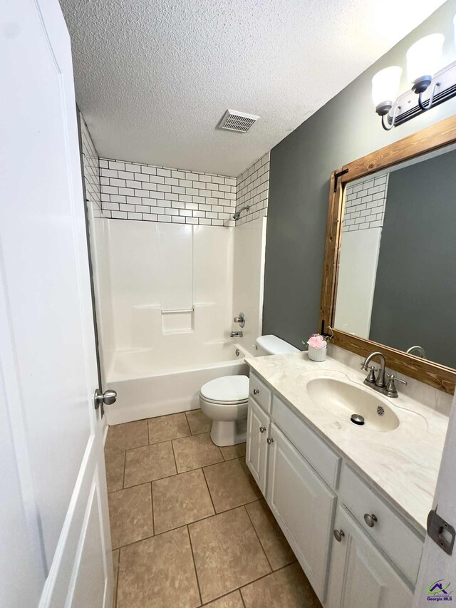 145 Rolling Woods Cir, Warner Robins, GA 31088 - bathroom with vanity, a textured ceiling, shower / washtub combination, and tile patterned flooring