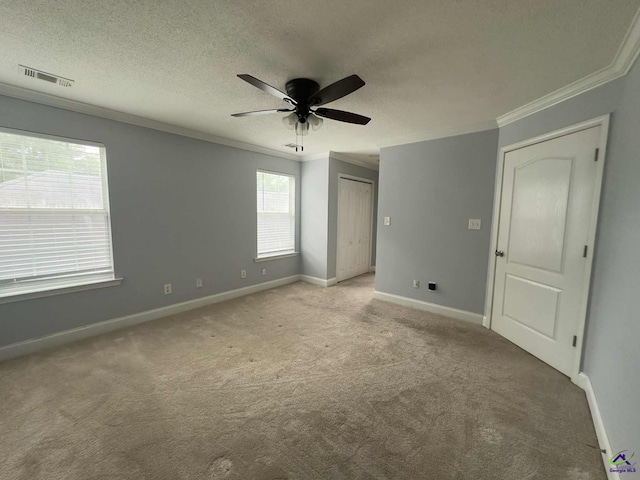 145 Rolling Woods Cir, Warner Robins, GA 31088 - unfurnished bedroom with ornamental molding, light carpet, a textured ceiling, and ceiling fan
