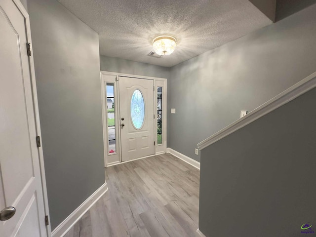 145 Rolling Woods Cir, Warner Robins, GA 31088 - foyer entrance with a textured ceiling and wood finished floors