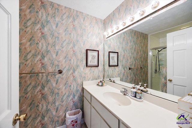 1414 Park Ave, Perry, GA 31069 - bathroom with vanity, a stall shower, and wallpapered walls