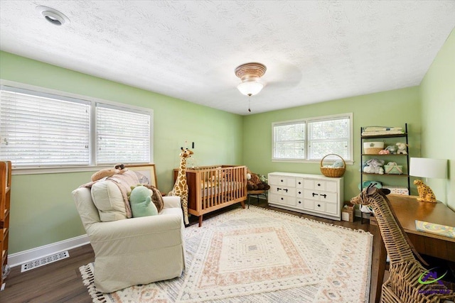 1414 Park Ave, Perry, GA 31069 - bedroom with wood finished floors, a textured ceiling, and ceiling fan