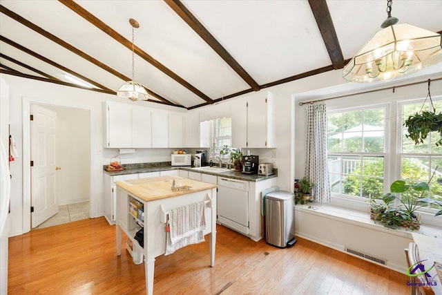 1414 Park Ave, Perry, GA 31069 - kitchen with white appliances, a chandelier, beam ceiling, white cabinets, and light wood-style flooring