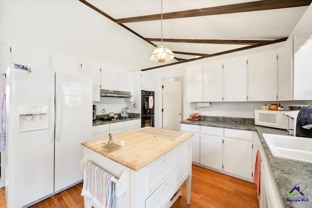 1414 Park Ave, Perry, GA 31069 - kitchen with black appliances, white cabinets, light wood finished floors, a kitchen island, and beamed ceiling