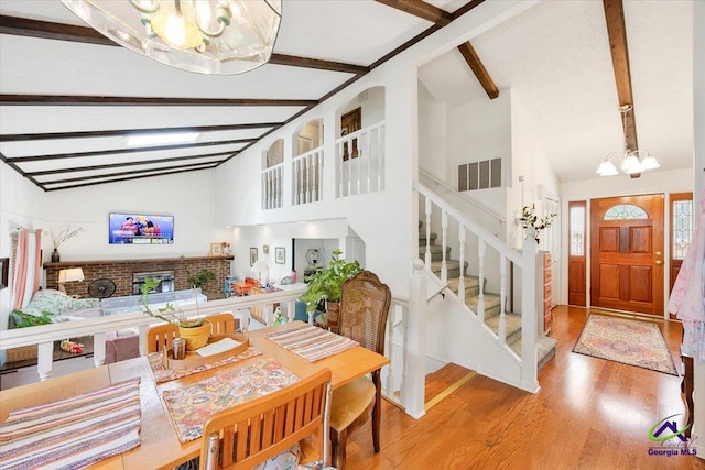 1414 Park Ave, Perry, GA 31069 - dining area featuring a chandelier, wood finished floors, beamed ceiling, stairway, and high vaulted ceiling
