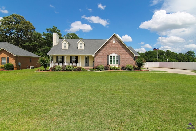 100 Scarlett Dr, Warner Robins, GA 31088 - cape cod home with a porch, a chimney, and brick siding