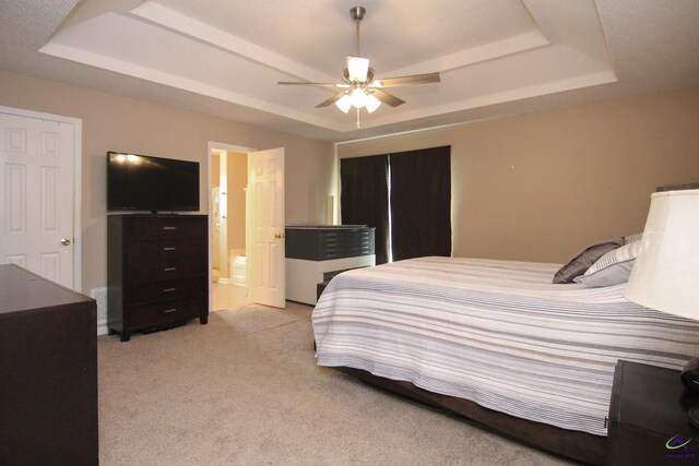 100 Scarlett Dr, Warner Robins, GA 31088 - bedroom with a tray ceiling, light carpet, a ceiling fan, and ensuite bathroom