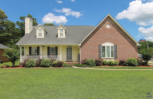 100 Scarlett Dr, Warner Robins, GA 31088 - cape cod home with a chimney, covered porch, a front lawn, a shingled roof, and brick siding