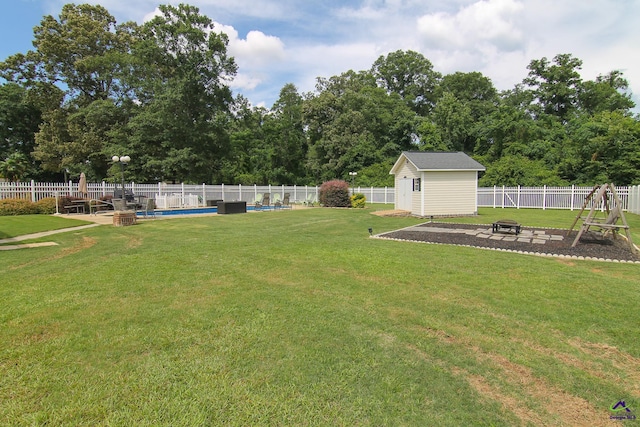100 Scarlett Dr, Warner Robins, GA 31088 - fenced backyard with an outdoor fire pit and a storage unit