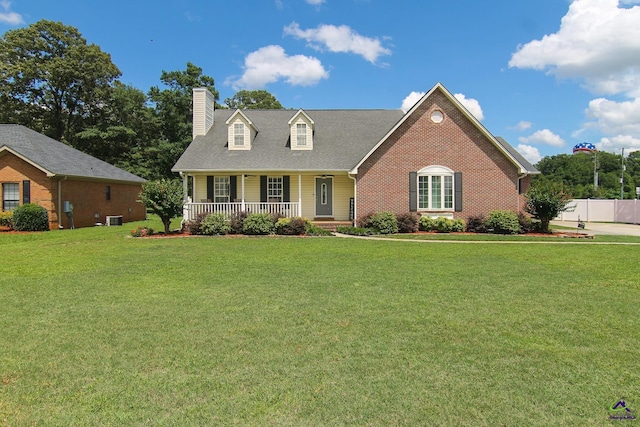100 Scarlett Dr, Warner Robins, GA 31088 - new england style home featuring covered porch, a chimney, and brick siding