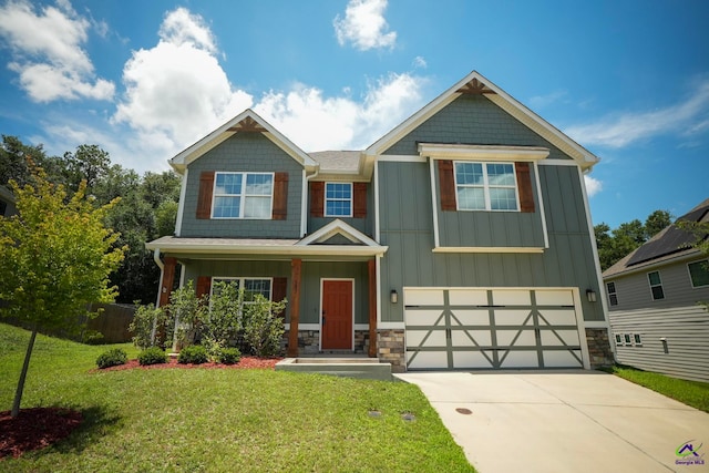 133 W River Cane Run, Perry, GA 31069 - craftsman-style house with concrete driveway, a garage, board and batten siding, a front lawn, and stone siding