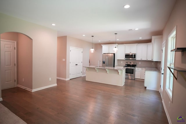 133 W River Cane Run, Perry, GA 31069 - kitchen with appliances with stainless steel finishes, a breakfast bar area, recessed lighting, tasteful backsplash, and white cabinetry