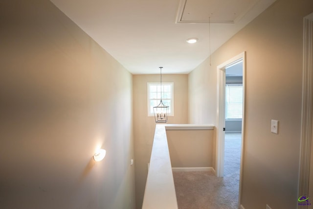 133 W River Cane Run, Perry, GA 31069 - corridor featuring attic access, carpet, an upstairs landing, and a chandelier
