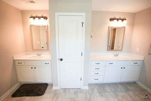 133 W River Cane Run, Perry, GA 31069 - bathroom featuring two vanities and baseboards