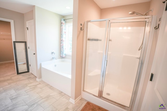 133 W River Cane Run, Perry, GA 31069 - full bathroom with a shower stall, a garden tub, and a walk in closet